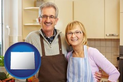 colorado map icon and a senior couple standing in their apartment kitchen
