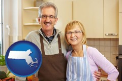massachusetts map icon and a senior couple standing in their apartment kitchen