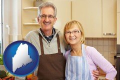 maine map icon and a senior couple standing in their apartment kitchen