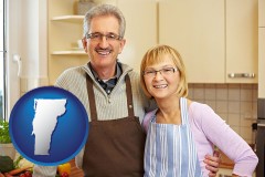 vermont map icon and a senior couple standing in their apartment kitchen