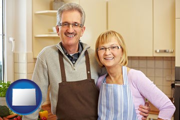 a senior couple standing in their apartment kitchen - with Colorado icon
