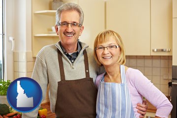 a senior couple standing in their apartment kitchen - with Idaho icon