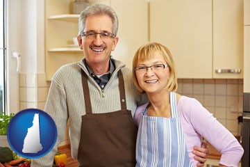 a senior couple standing in their apartment kitchen - with New Hampshire icon