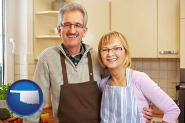 a senior couple standing in their apartment kitchen - with Oklahoma icon