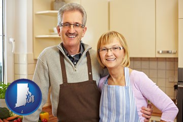 a senior couple standing in their apartment kitchen - with Rhode Island icon