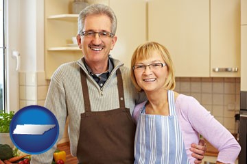 a senior couple standing in their apartment kitchen - with Tennessee icon